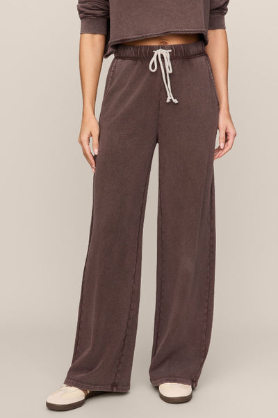 Model wearing Z Supply Hunter knit pants with an elastic drawcord waistband, side pockets, and full-length straight legs;Z Supply Hunter Knit Pants
women’s knit denim pants
women’s French terry pants
mineral wash pants for women
full-length pull-on pants
women’s drawstring waistband pants
women’s side pocket knit pants
casual wide-leg pants women
cotton blend lounge pants
relaxed everyday pants women; DARK CHOCOLATE