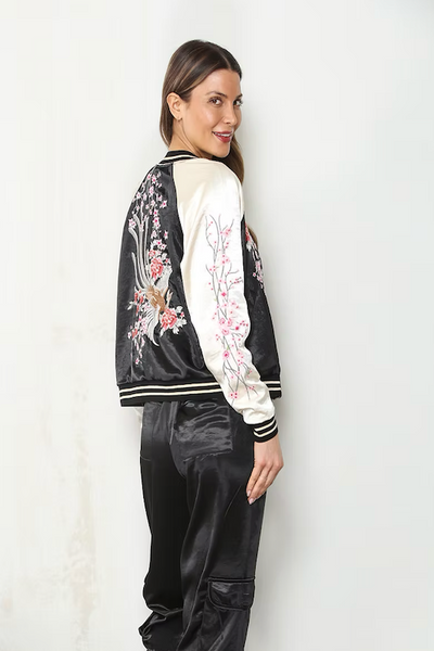 Side and back view of reversible satin bomber jacket showing pink cherry blossom embroidery on black back and cream sleeve;Paparazzi reversible bomber jacket
cherry blossom embroidered bomber jacket
reversible satin bomber jacket women
black and cream floral bomber jacket
blush pink satin bomber jacket
embroidered floral jacket women
hammered satin bomber jacket
pink cherry blossom jacket
women’s reversible floral jacket
satin bomber jacket with embroidery