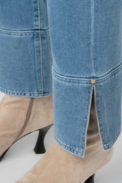 Close-up detail of Liverpool Kennedy Straight Jean cuff and side slit hem with button accent, styled with beige block heels