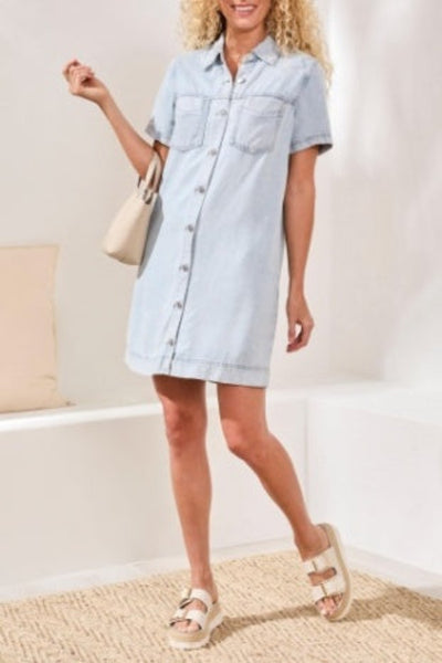 Light wash lyocell denim shirt dress with button front, chest patch pockets, short sleeves with cuff detail, and above-knee length — front view.