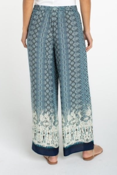 Back view of Liverpool palazzo pants with blue geometric ombré print on model