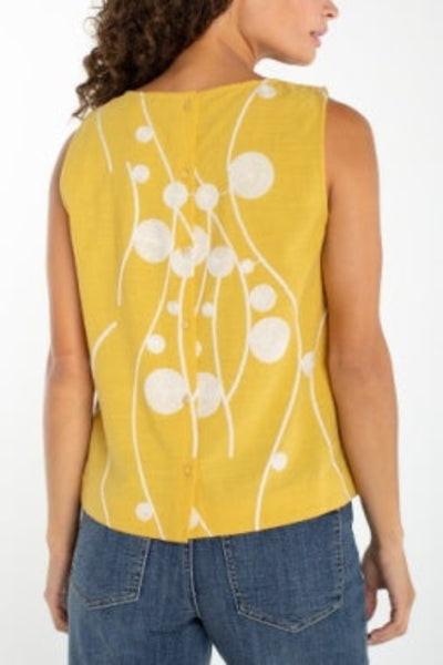 Yellow and white abstract dot print sleeveless woven top, back view, paired with blue jeans.
