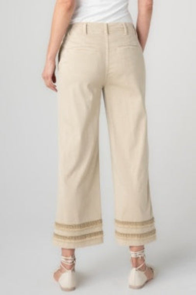 Safari Sand crop wide leg pants with fray and lace hem detail, back view, paired with white top and neutral sandals