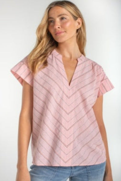 Pink multi-stitch popover top with chevron stitching detail, front view, paired with blue jeans.