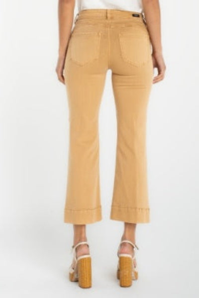 Hannah crop flare hugger jeans with cut hem, back view, paired with platform sandals and white top.
