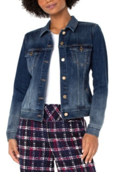 Model is wearing Liverpool Classic Jean Jacket in ombre dark wash denim with golden hardware, front view, styled with white tee and plaid pants.