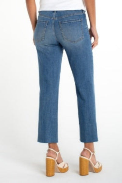Light wash Kennedy crop straight jeans with blind hem, back view, paired with white top and platform sandals.