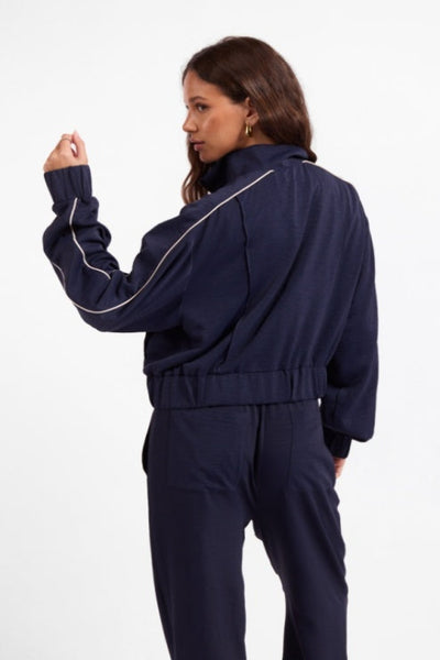 Back view of Sage the Label Bike Ride navy track jacket with ivory sleeve piping;Sage the Label Bike Ride Track Jacket
Sage the Label navy track jacket
women’s navy and ivory track jacket
women’s cropped track jacket
navy jacket with ivory piping
sporty chic jacket for women
women’s matching track set
relaxed fit zip-front jacket
women’s boutique athleisure jacket
navy cropped lightweight jacket