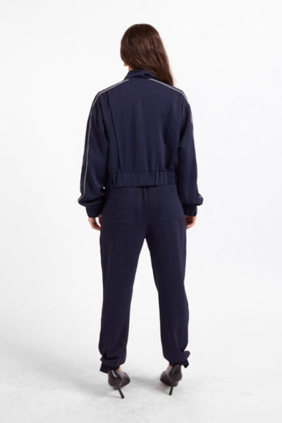 Back view of Sage the Label Bike Ride navy joggers and matching jacket set;Sage the Label Bike Ride Joggers
Sage the Label navy joggers
women’s navy and ivory joggers
navy joggers with ivory piping
women’s tapered jogger pants
women’s pull-on track pants
women’s matching track set
lined polyester joggers for women
sporty chic navy pants
relaxed-fit ankle joggers