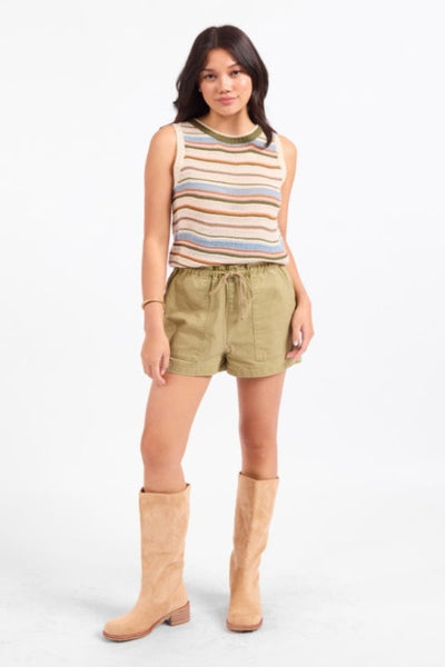 Sadie & Sage Fall Stripe Sweater Vest in multi-toned open knit with horizontal stripes in earthy hues of blue, rust, olive, and cream, crew neckline with ribbed trim, relaxed straight silhouette — front view styled with olive shorts and knee-high boots.