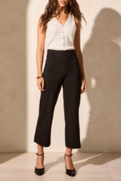 Black high-rise ponte capri pants with pockets, styled with white sleeveless top and black heels — front full-length view.