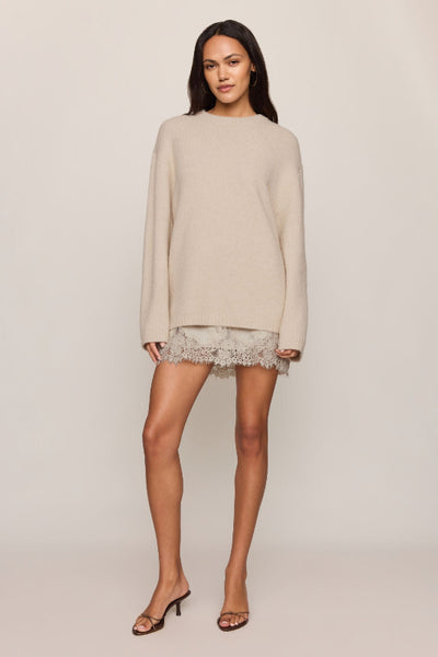 Z Supply Chill Mode Sweater in Frosted Pearl styled with a lace-trim skirt and heels. Z Supply Chill Mode Sweater; Z Supply Frosted Pearl sweater; Z Supply ZW264778; women's fluffy knit sweater; women's fuzzy crewneck sweater; long sleeve neutral sweater; relaxed fit knit pullover; women's cozy sweater; Frosted Pearl crewneck pullover; women's soft textured sweater.

