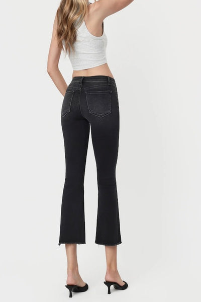 VERVET faded black mid-rise crop flare jeans with raw stepped hem — back view styled with white crop top and black heeled mules