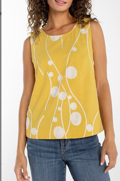 Yellow and white abstract dot print sleeveless woven top, front view, paired with blue jeans